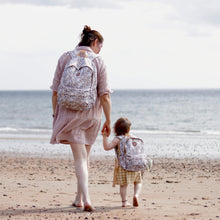 Load image into Gallery viewer, Woman and child walking on a beach with patterned backpacks.
