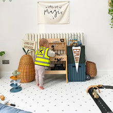 Load image into Gallery viewer, Child playing with toys in a room with a 'Builder' vest and various play items.
